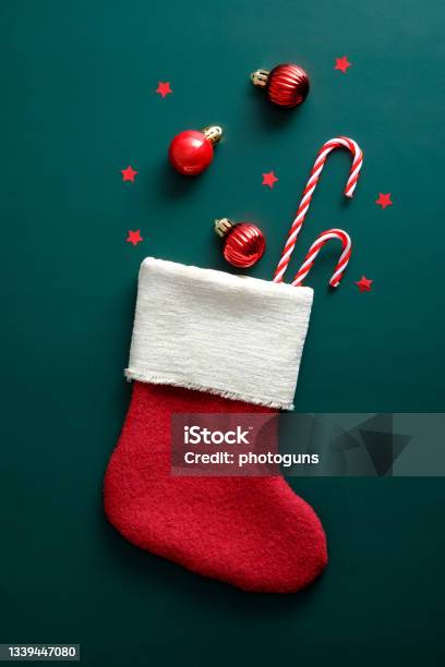 Vintage Santa Stocking With Candy Canes Red Balls And Decorations On Green Background Stock Photo - Download Image Now