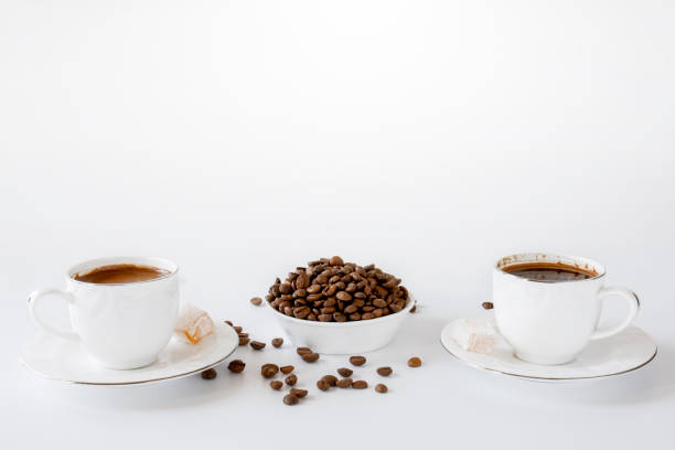 istock Two cups of Turkish coffee and beans on a white background 1339448217