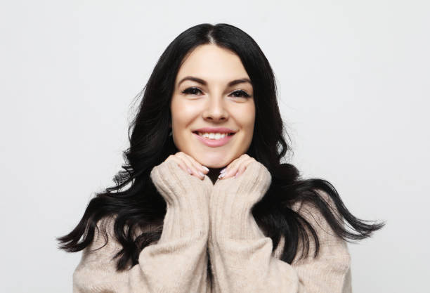 istock positive female with cheerful expression, dressed in casual clothes, over white background. Beautiful woman indoor 1339448371