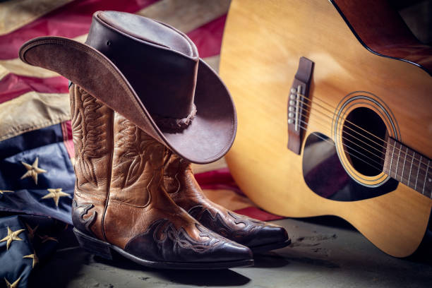 Country music festival live concert with acoustic guitar, american flag, cowboy hat and boots Country music festival live concert with acoustic guitar, antique american flag, cowboy hat and boots usa flag shoes stock pictures, royalty-free photos & images
