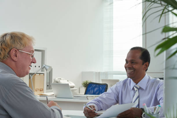 istock Middle-aged Businessman Showing Report 1339449653