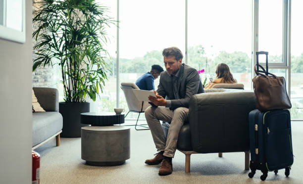 istock Businessman Using Digital Tablet while Waiting for his Flight in the Business Lounge 1339451584