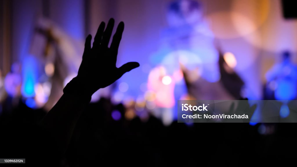 Hands raising concert, hands raising for religion background blurred, silhouette Church Stock Photo