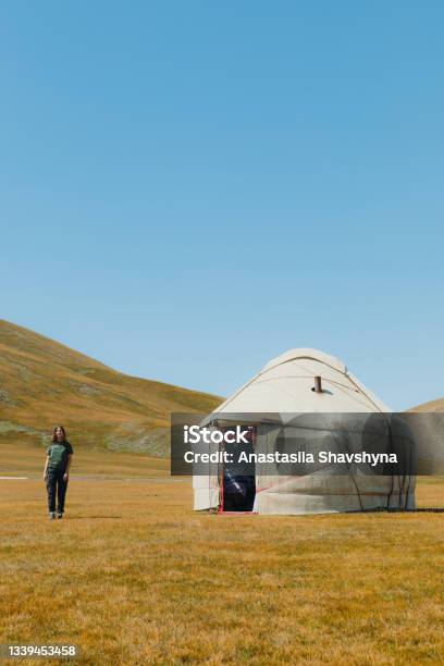 Young Smiling Woman Meets Morning In The Mountains From Yurt Camp In Kyrgyzstan Stock Photo - Download Image Now