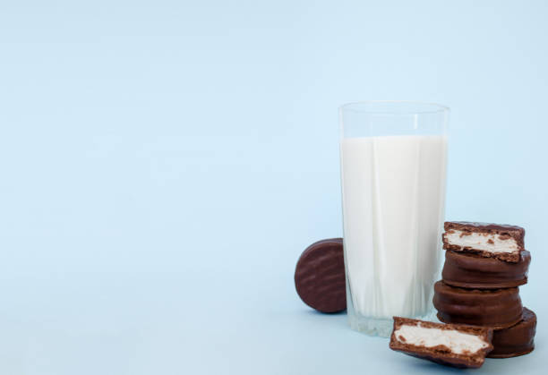 istock chocolate chip cookies with milk on a blue background, copy space 1339454849