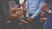 istock People praying together at Church. 1339455667
