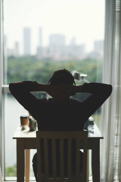 istock Young Man Leaning Back in Chair 1339455824