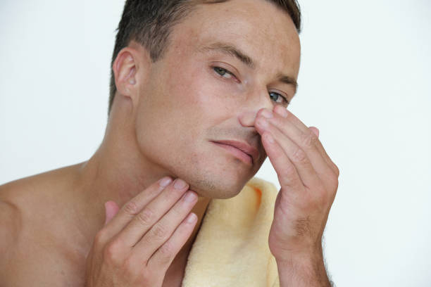 istock Man Looking for Skin Imperfections, 1339455844