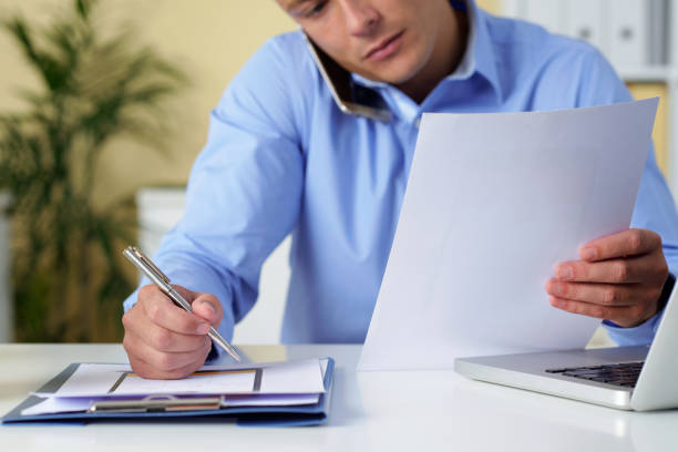 istock Businessman Writing Down Details 1339455856