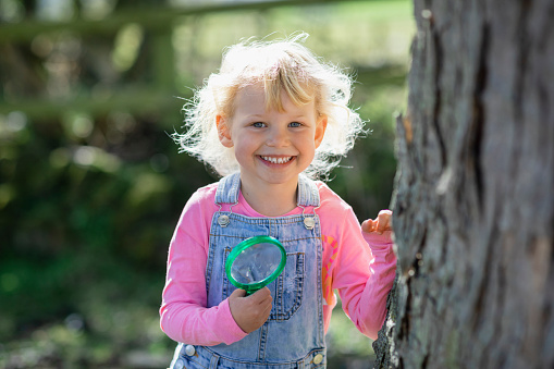 Toothless happy smile of a girl with a fallen lower milk tooth close-up. Changing teeth to molars in childhood