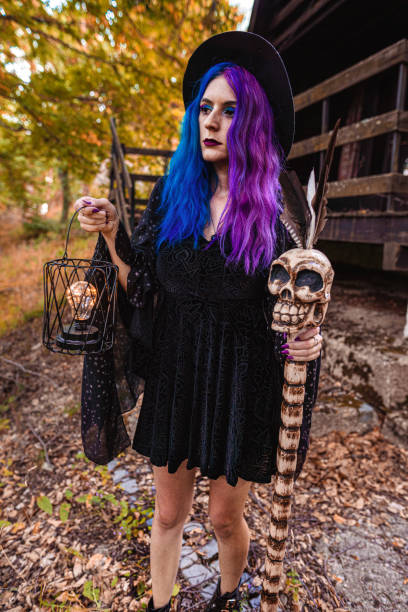 young witch in front of her house in a forest. - magic magic trick vertical tarot cards imagens e fotografias de stock