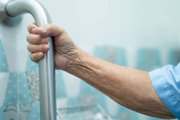 istock Asian senior or elderly old lady woman patient use slope walkway handle security with help support assistant in nursing hospital ward, healthy strong medical concept. 1339459016