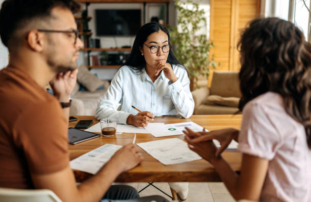 istock Young couple getting advice from financial expert 1339459620