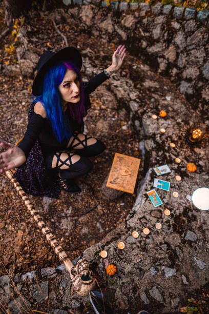 young witch, fortune teller reads tarot cards. - magic magic trick vertical tarot cards imagens e fotografias de stock