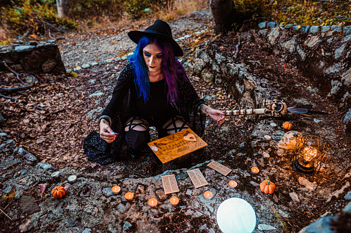 Young witch, fortune teller reads Tarot cards.