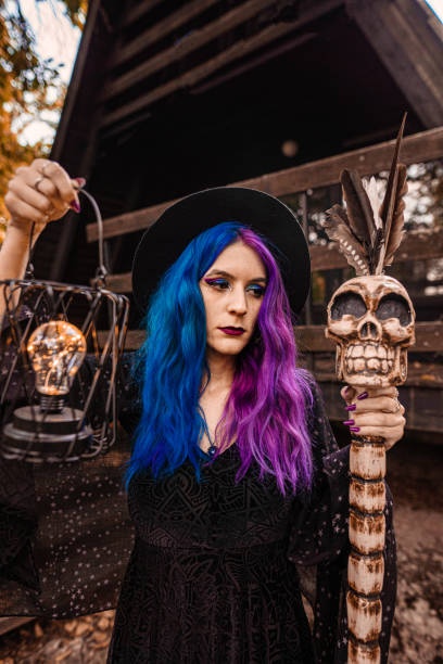 young witch in front of her house in a forest. - magic magic trick vertical tarot cards imagens e fotografias de stock