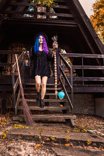 young witch in front of her house in a forest. - magic magic trick vertical tarot cards imagens e fotografias de stock