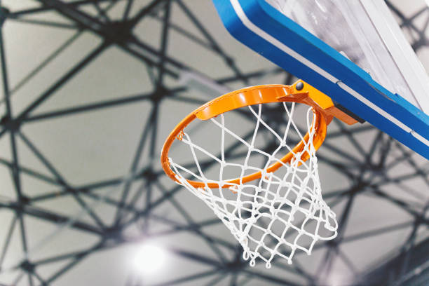 Basketball basket at a sports arena. Scoring the winning points at a basketball game. Basketball arena background Basketball basket at a sports arena. Scoring the winning points at a basketball game. Basketball arena background college basketball court stock pictures, royalty-free photos & images