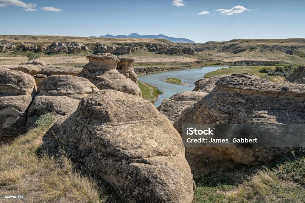 Rock Hoodoo on the Bank of the Milk River Rock formations on the edge of the Milk River in Writing on Stone Provincial Park in Alberta, Canada Milk River Stock Photo
