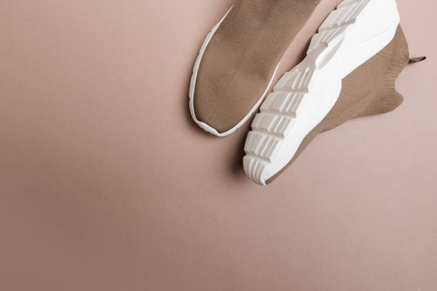 istock modern beige sneakers with white soles on beige background 1339462208