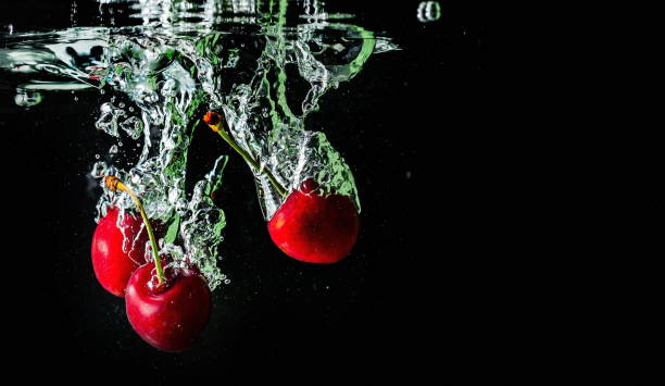 istock ripe cherries fall into the water raising splashes and air bubbles 1339465021