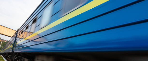 istock a blue passenger train travels along the track 1339466279