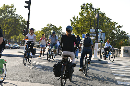 Paris, France-09 07 2021:Group of cyclists using cycle paths cross at a crossroads in Paris, France.
