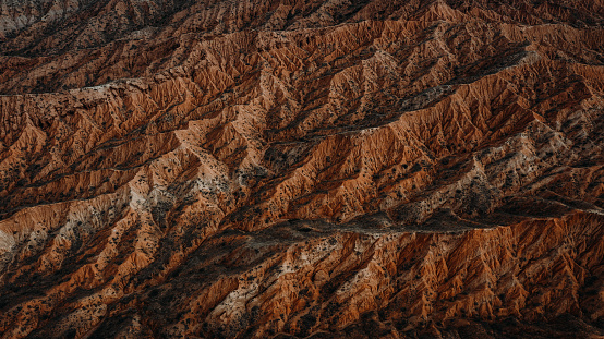 Drone photo go majestic Skazka orange canyon with curved texture near Issyk-Kul lake, Central Asia