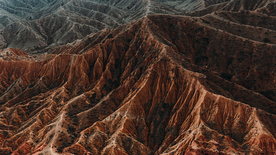 Drone photo go majestic Skazka orange canyon with curved texture near Issyk-Kul lake, Central Asia