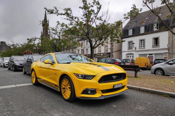 Huelgoat, France - September 08 2021: Yellow Ford Mustang GT 5.0 parked in the city center.