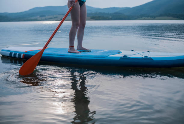 istock Low Section Of Woman Paddleboarding In Lake 1339470549