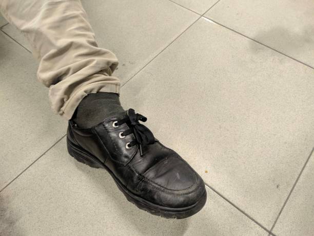 istock a black shoe and cream colored trousers 1339470588