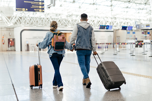 Couple at the airport walking to board