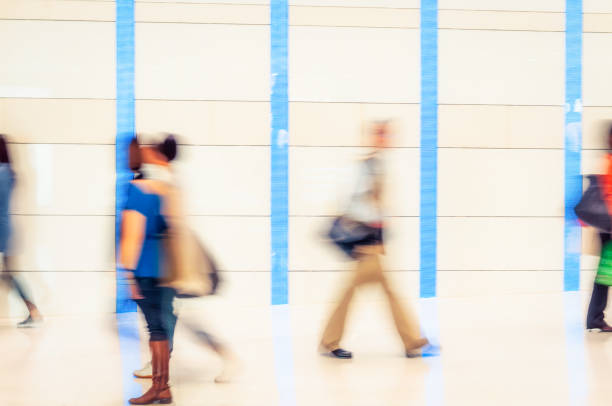 Long exposure blur from the movement of pedestrians in an indoor walkway in Hong Kong.