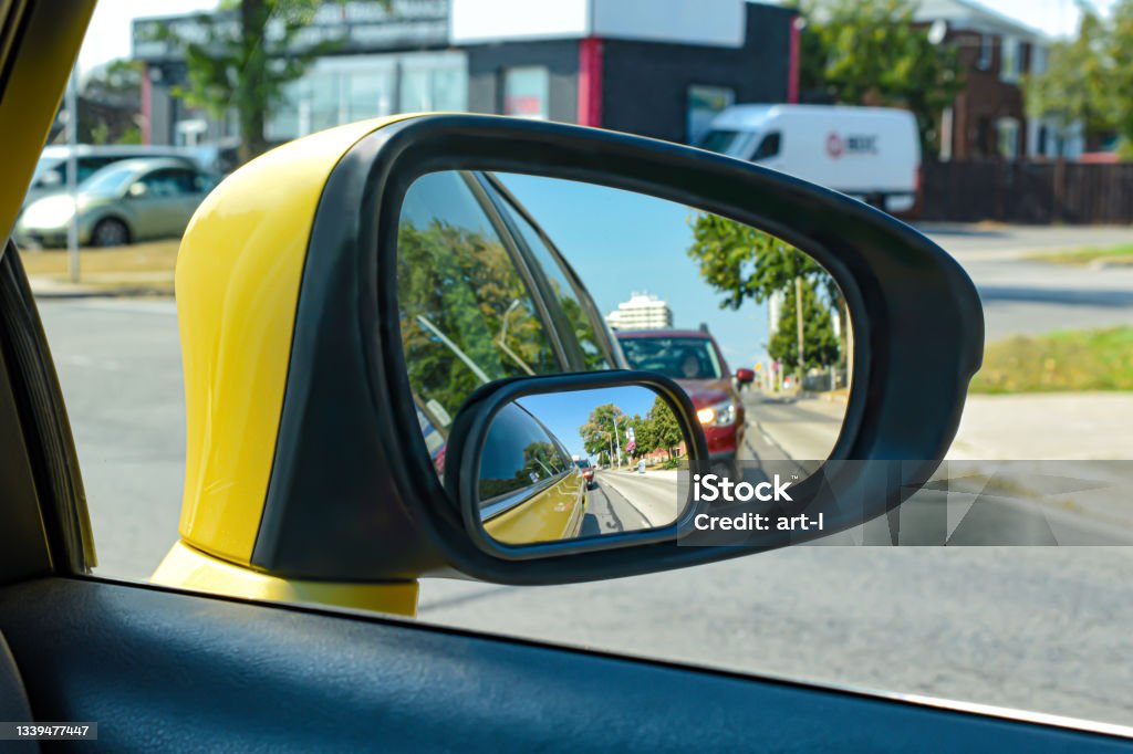Square Blind Spot Mirrors The view from a motor vehicle side mirror through the window. The image layers up due to the blind spot mirror giving a different angle of view. Vehicle blind spot Stock Photo