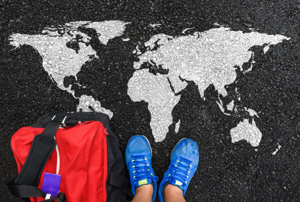 istock World map on an asphalt road an man in shoes 1339478071