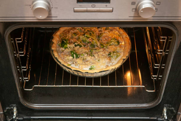 istock Open shortbread pie with chicken and broccoli, sprinkled with cheese, baked in the oven 1339478392