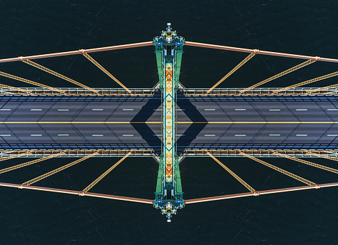 Looking down from the top of a suspension bridge tower. Symmetrical composite.