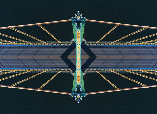 Bridge Tower Symmetry Looking down from the top of a suspension bridge tower. Symmetrical composite. symmetry photos stock pictures, royalty-free photos & images