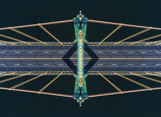 Looking down from the top of a suspension bridge tower. Symmetrical composite.