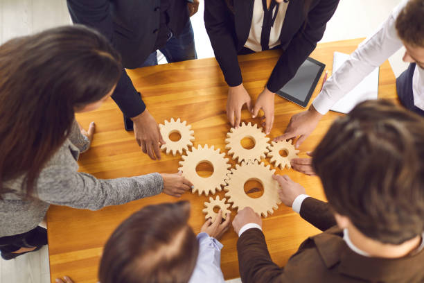 istock Startup team joining cogwheels as metaphor for teamwork, management and finding business solutions 1339482904