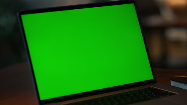 Green screen laptop computer closeup. Closeup mockup display computer