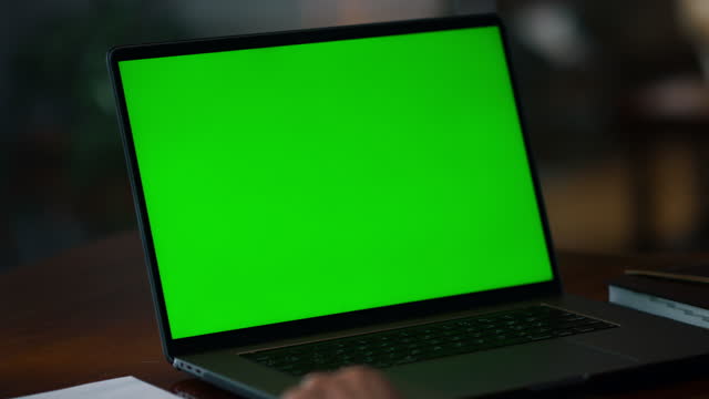 Closeup green screen laptop on table. Laptop computer with mockup display