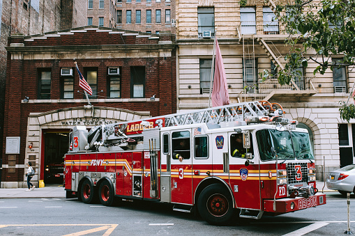 Manhattan, New York, USA - August 28, 2021.  Fire truck of Fire department of the city of New York leaving fire station in East Village.