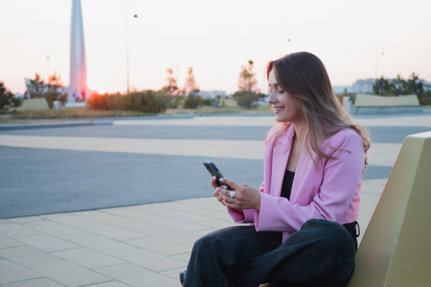 istock A beautiful laughing brunette uses a smartphone to communicate, 1339491090