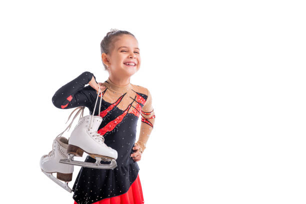 Portrait of little laughing skater with skates in her hands Portrait of a little laughing skater with skates in her hands figure skating stock pictures, royalty-free photos & images