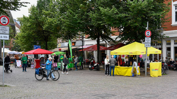 Downtown Ahrensburg with market stalls for the federal election Ahrensburg, Germany, September 4, 2021 - Downtown Ahrensburg with market stalls for the federal election, some unidentified people in the background german free democratic party photos stock pictures, royalty-free photos & images