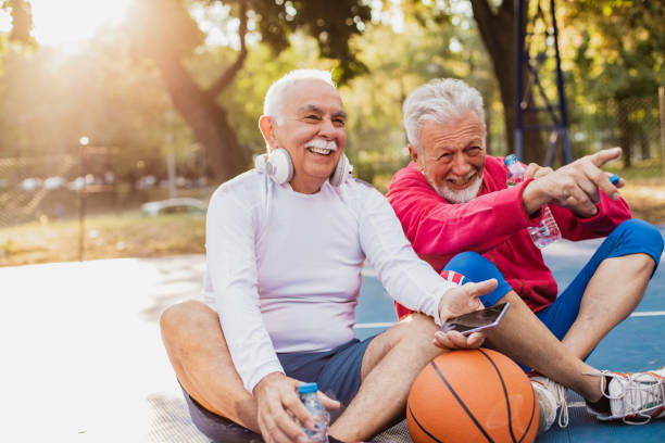 istock Two active senior men on basketball field taking a break from sport activity 1339504244