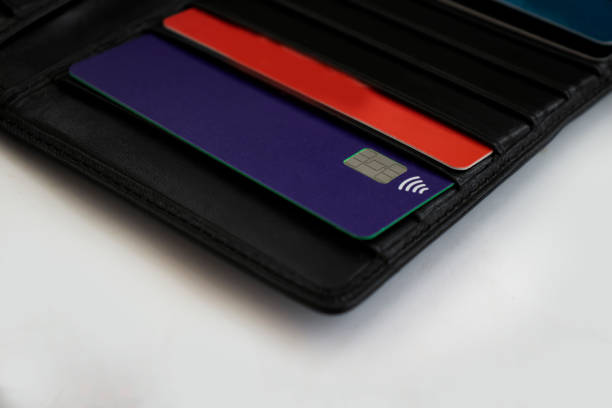 istock bank card black wallet background 1339509616