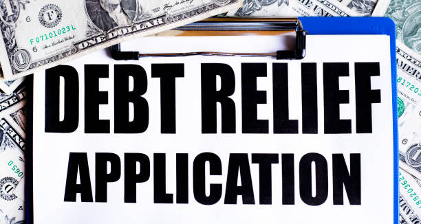 istock Background of US One Dollar Bills.Application for Debt Relief. 1339511082